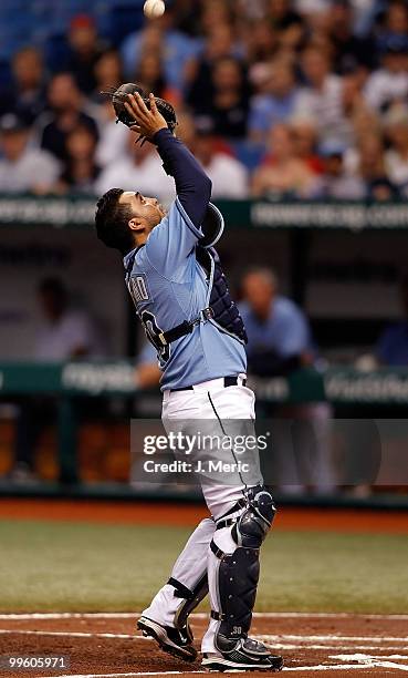 Catcher Dioner Navarro of the Tampa Bay Rays catches a foul ball against the Seattle Mariners during the game at Tropicana Field on May 16, 2010 in...