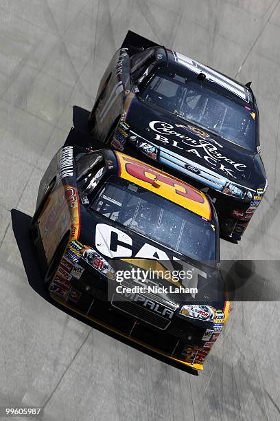 Jeff Burton, driver of the Caterpillar Chevrolet, leads Matt Kenseth, driver of the Crown Royal Black Ford, during the NASCAR Sprint Cup Series...