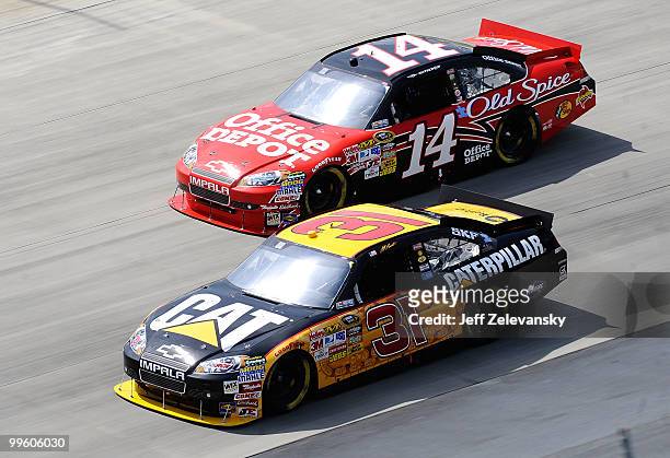 Jeff Burton, driver of the Caterpillar Chevrolet, and Tony Stewart, driver of the Office Depot Chevrolet, race side by side during the NASCAR Sprint...