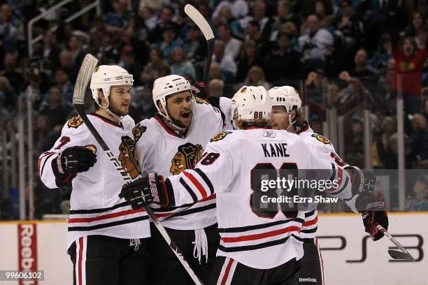 Dustin Byfuglien of the Chicago Blackhawks reacts with teammates after his third period goal against the San Jose Sharks in Game One of the Western...