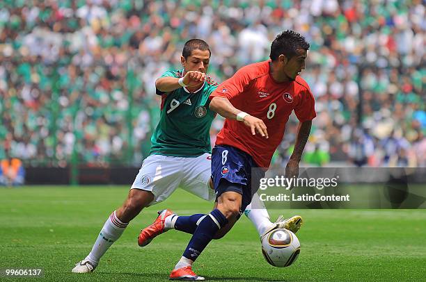 Javier Hernandez of Mexico fights for the ball with Arturo Vidal of Chile, during a friendly match as part of the Mexico National team preparation...