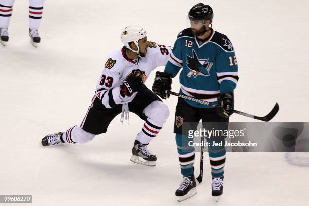Dustin Byfuglien of the Chicago Blackhawks reacts after scoring the game-winning goal as Patrick Marleau of the San Jose Sharks looks on in Game One...