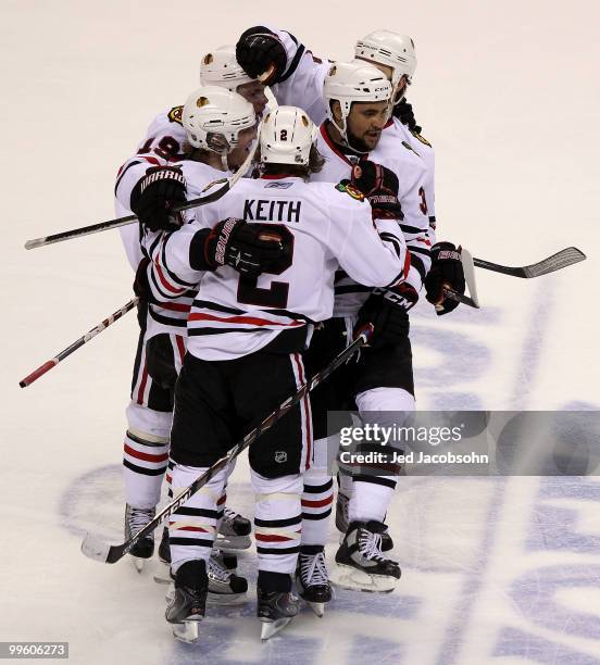 Dustin Byfuglien of the Chicago Blackhawks reacts with teammates after his third period goal against the San Jose Sharks in Game One of the Western...