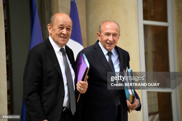 French Foreign Affairs Minister Jean-Yves Le Drian and French Interior Minister Gerard Collomb leave on July 11, 2018 after a weekly cabinet meeting...