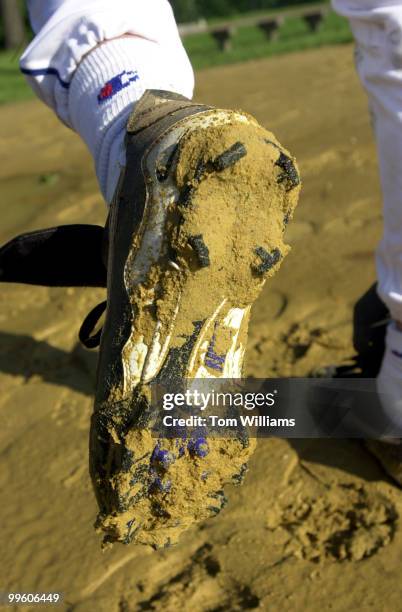Rep. Anthony Weiner, D-NY, displays muddy cleats at the Democrat's baseball pratice, Wednesday morning.