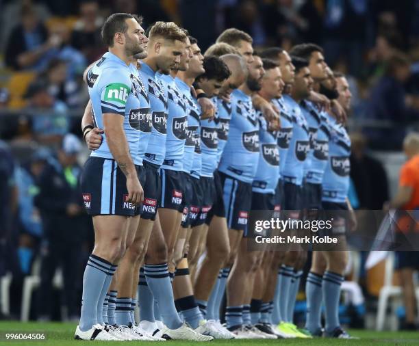 The Blues stand for the national anthem during game three of the State of Origin series between the Queensland Maroons and the New South Wales Blues...