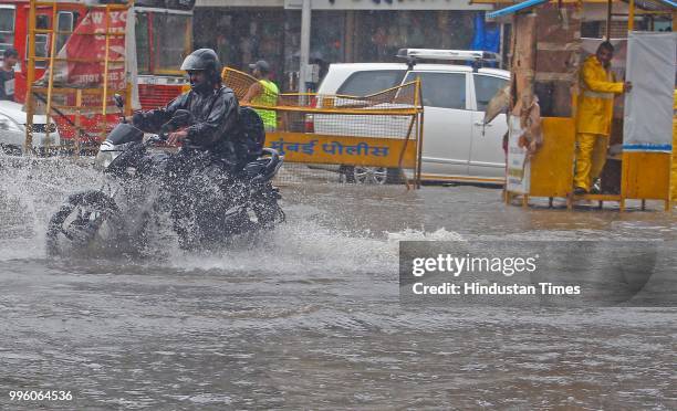 Vehicles wade through water-logged roads during heavy rains, on July 10, 2018 in Mumbai, India. Heavy rains across Mumbai city and adjoining areas...