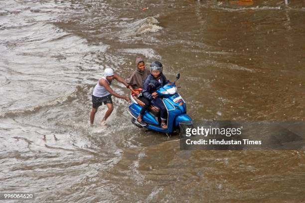 Vehicles wade through water-logged roads during heavy rains, on July 10, 2018 in Mumbai, India. Heavy rains across Mumbai city and adjoining areas...