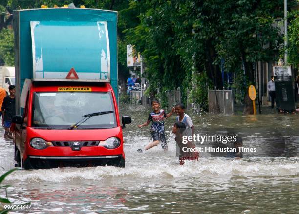 Vehicles wade through water-logged roads during heavy rains, on July 10, 2018 in Mumbai, India. Heavy rains across Mumbai city and adjoining areas...