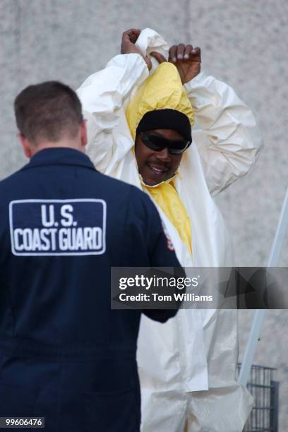 On Monday, a man gets into a hazmat suit and prepares to enter Hart Building continuing the anthrax clean up.