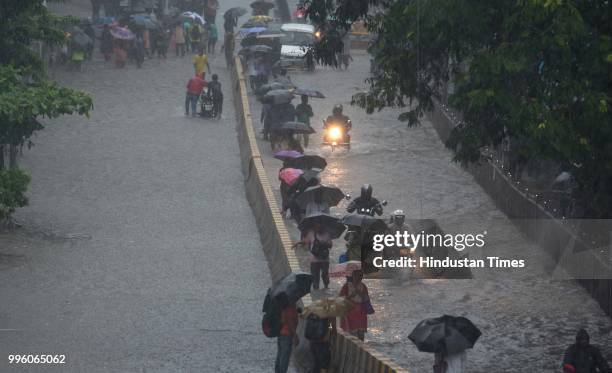 Commuters facing problem due to heavy rain water logging at Parel, on July 10, 2018 in Mumbai, India. Heavy rains across Mumbai city and adjoining...