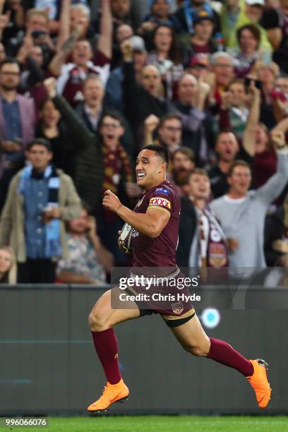 Valentine Holmes of Maroons makes a break to score a try during game three of the State of Origin series between the Queensland Maroons and the New...