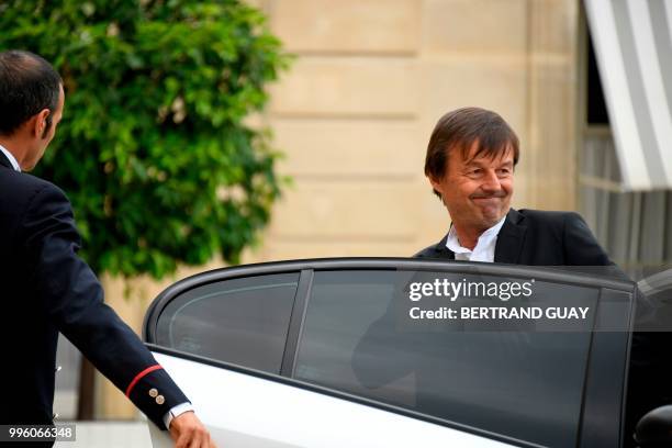 French Minister for the Ecological and Inclusive Transition Nicolas Hulot enter a car as he leaves on July 11, 2018 after a weekly cabinet meeting at...