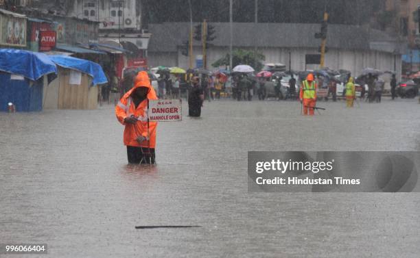 Open manhole sign board at Hindmata, on July 10, 2018 in Mumbai, India. Heavy rains across Mumbai city and adjoining areas continue to affect normal...