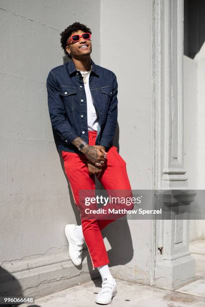 Kelly Oubre Jr. Is seen on the street attending Men's New York Fashion Week wearing denim jacket and red pants on July 10, 2018 in New York City.