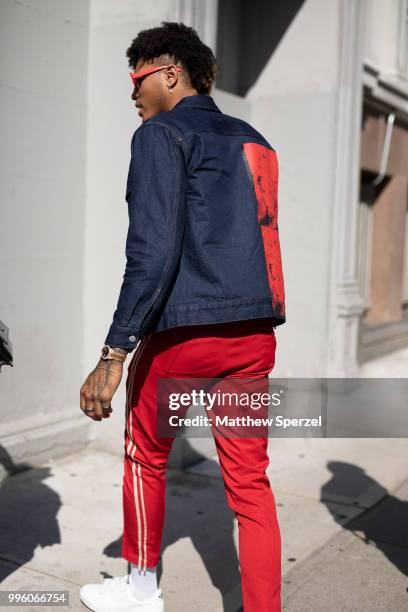 Kelly Oubre Jr. Is seen on the street attending Men's New York Fashion Week wearing denim jacket and red pants on July 10, 2018 in New York City.