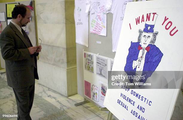 Sen. Paul Wellstone views works at an exhibit "Domestic Violence: Through the Eyes of A Child" featuring art work of children who hae witnessed...