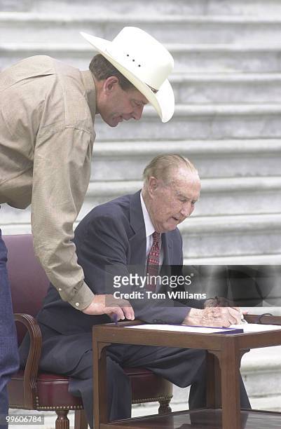 Sen Strom Thurmond signs a bill that will repeal the death Tax while Lynn Cornwell, President-elect of the National Cattlemans Beef Association,...