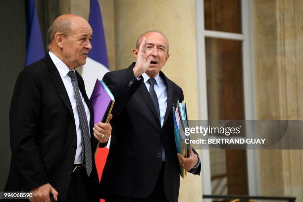 French Foreign Affairs Minister Jean-Yves Le Drian and French Interior Minister Gerard Collomb leave on July 11, 2018 after a weekly cabinet meeting...