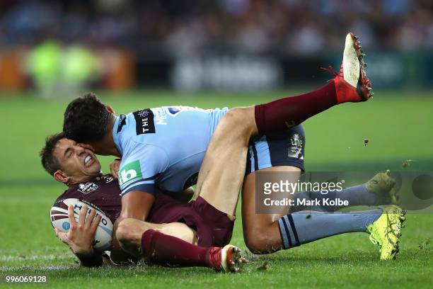 Billy Slater of Queensland is tackled by Latrell Mitchell of the Blues during game three of the State of Origin series between the Queensland Maroons...