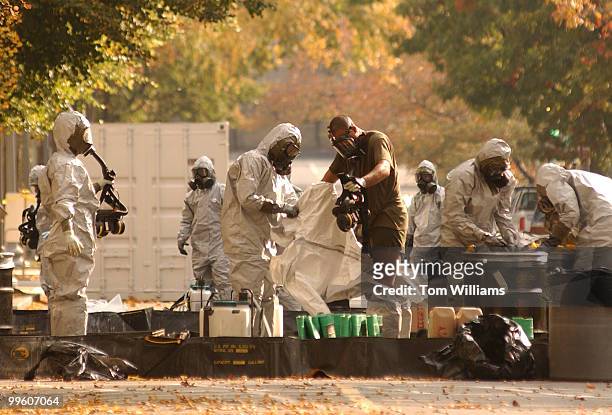Workers in Hazardous Material suits regroup on South Capitol St. After sweeping House Office Buildings for anthrax.