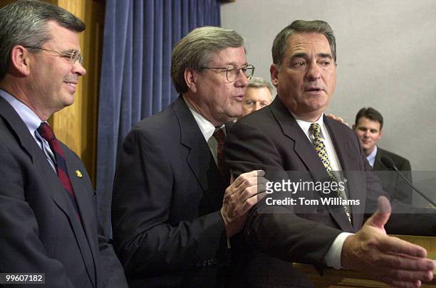 Rep. Bill Thomas, R-CA, whispers a point to Rep. Billy Tauzin, R-LA,during a press conference on "The Patients' Bill of Rights Act of 2001" in the...