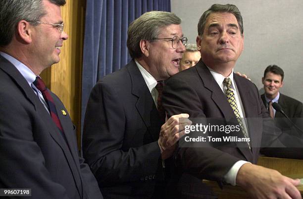 Rep. Bill Thomas, R-CA, whispers a point to Rep. Billy Tauzin, R-LA,during a press conference on "The Patients' Bill of Rights Act of 2001" in the...