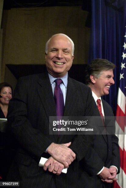 Sen. John McCain, R-AZ, and Rep. Marty Meehan, D-MA, share a laugh at a press conference about the newly introduced McCain-Feingold-Cochran campaign...