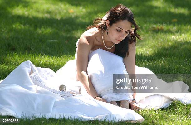 Demetra Georgiou of New York, rests after a march on Capitol Hill and the Mall to urge Congress to provide funding for the Violence Against Women Act...