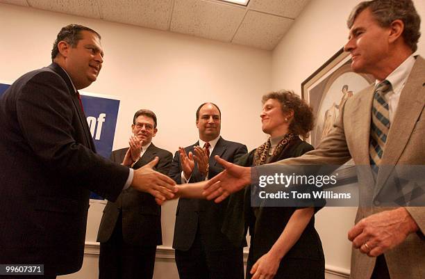 Secretary of Energy Spence Abraham, congratulates, from right, Jack and Laurie Corkey of St. Ann's Episcopal Church in Reston, Va., Chris Russell,...