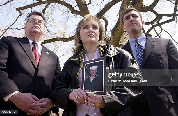 Reps. Peter King, R-NY, and Vito Fossella, R-NY stand beside Barbara DiStefano of Staten Island as she holds a picture of her brother Petty Officer...