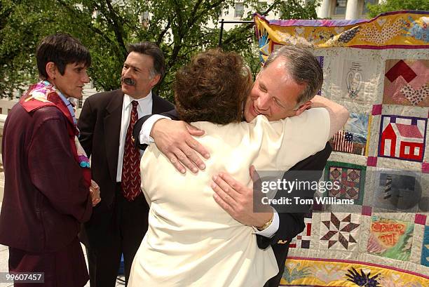 At right, Rep. Steve Israel, D-N.Y., hugs Susan Butler of the Ovarian Cancer National Alliance and cancer survivor, while Rep. Rosa Delauro, D-Conn.,...
