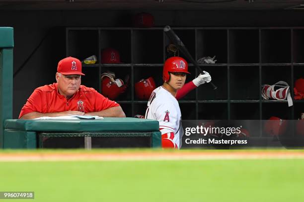 Manager Mike Scioscia and Shohei Ohtani of the Los Angeles Angels of Anaheim looks on during the MLB game against the Seattle Mariners at Angel...