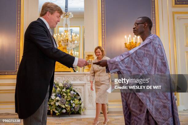 Dutch King Willem-Alexander accepts the diplomatic credentials of the Ambassador of the Republic of Senegal to The Netherlands, Momar Gueye, during a...