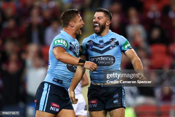 James Tedesco of the Blues celebrates scoring a try with Tariq Sims of the Blues during game three of the State of Origin series between the...