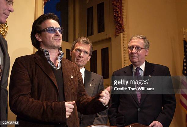 Bono, of the group U2, speaks to the press alongside Sens. Tom Daschle, D-S.D., and Mitch McConnell, R-Ky.