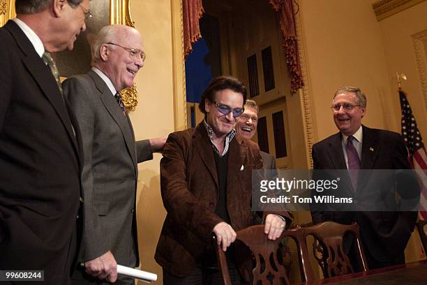 Bono, of the group U2, jokes with Sens. From left Trent Lott, R-Miss., Patrick Leahy, D-Vt., Tom Daschle, D-S.D., and Mitch McConnell, R-Ky, during a...
