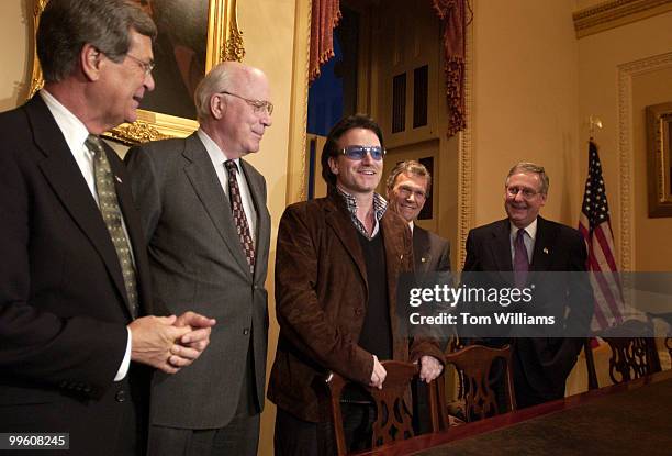 Bono, of the group U2, jokes with Sens. From left Trent Lott, R-Miss., Patrick Leahy, D-Vt., Tom Daschle, D-S.D., and Mitch McConnell, R-Ky, during a...
