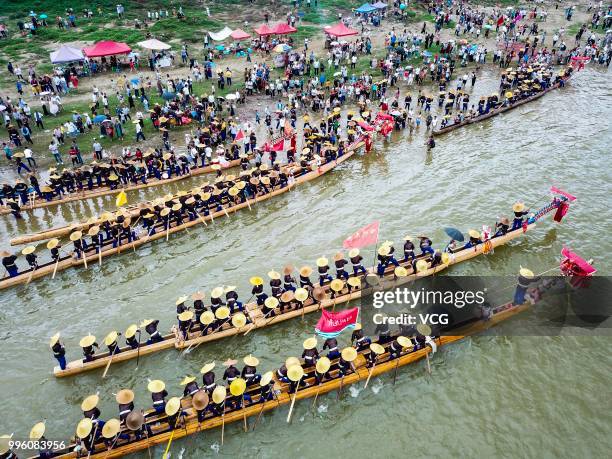 People of Miao Ethnic Group of Taijiang County compete in a dragon boat race on Qingshui River to celebrate the Dragon Canoe Festival at Shidong Town...