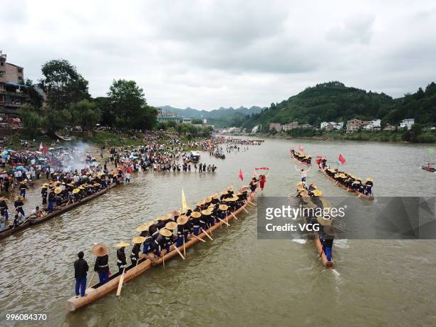 People of Miao Ethnic Group of Taijiang County compete in a dragon boat race on Qingshui River to celebrate the Dragon Canoe Festival at Shidong Town...
