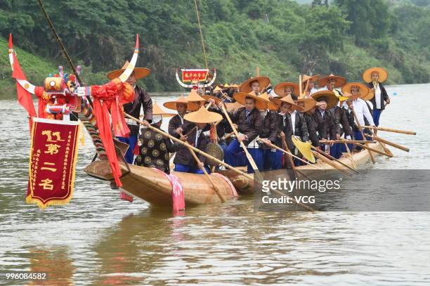 People of Miao Ethnic Group of Taijiang County compete in a dragon boat race on Qingshui River to celebrate the Dragon Canoe Festival at Shidong Town...