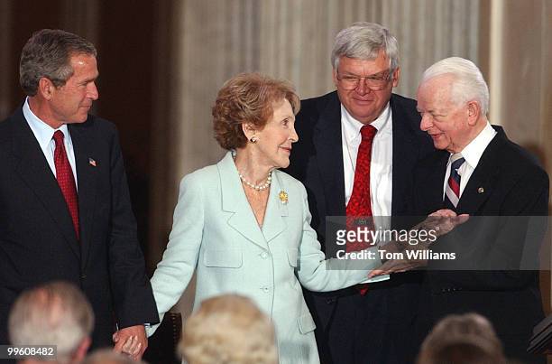 Former first lady Nancy Reagan is congratulated by Sen. Robert Byrd, D-W.V., while President George W. Bush, left, and Speaker Dennis Hastert,...