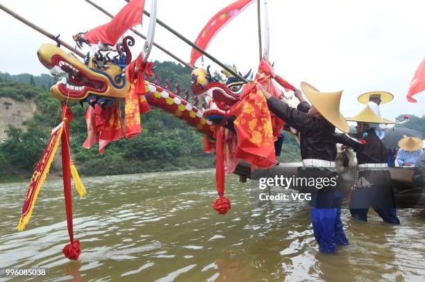 People of Miao Ethnic Group of Taijiang County compete in a dragon boat race on Qingshui River to celebrate the Dragon Canoe Festival at Shidong Town...