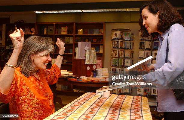 Author Elizabeth Berg sign books and talks with fans including, Natalie Markman, right, at Olsson's Books & Records in downtown Washington, D.C., May...