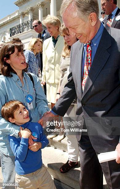 Sen. Jim Jeffords, I-Vt., greets one of his LA's Laurie Schultz Heim and her son, Nick at a news conference on the East Front Steps, commemerating...