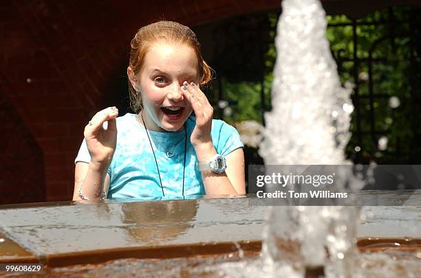 After a long day of visiting Washington, Katie Wade of Vienna, reacts as she gets a direct hit in a water fight with her cousin, in the Grotto on the...