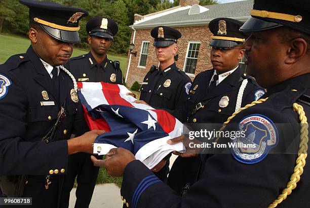 Capitol Police officers from left, K.L. Steward, D.R. Simpson Jr., J.E. Burnett, K.A. Young, and T.L. Lewis, fold the American Flag before the...