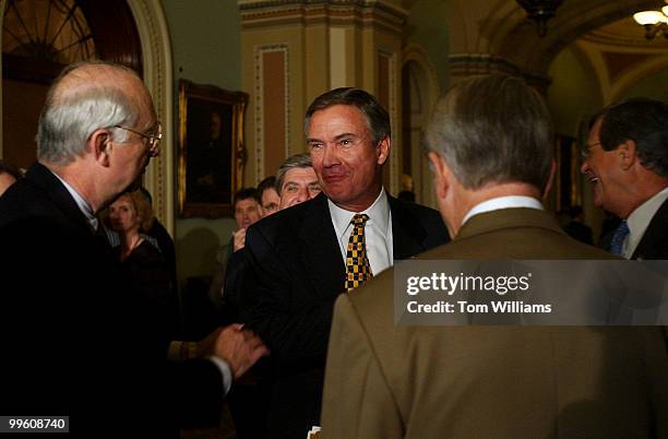 Sen. Phil Gramm, R-Texas, left, tries to get Sen. John Breux, to join a question and answer session with reporters after the Senate Luncheons,...