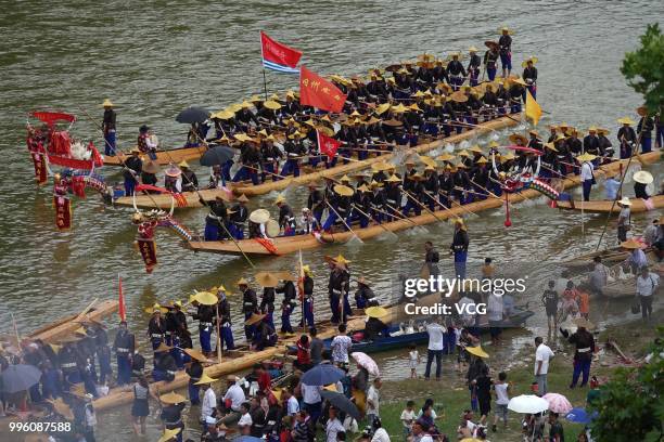 People of Miao Ethnic Group of Taijiang County compete in a dragon boat race on Qingshui River to celebrate the Dragon Canoe Festival at Shidong Town...