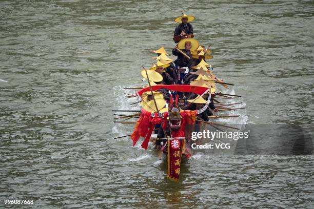 People of Miao Ethnic Group of Taijiang County compete in a dragon boat race on Qingshui River to celebrate the Dragon Canoe Festival at Shidong Town...